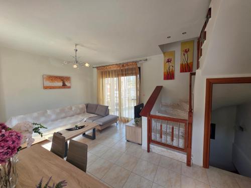a living room with a couch and a table at Anthemia Luxurious Villa in Iraklitsa