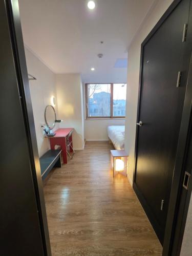 a hallway of a room with a bed and a window at Quantum Hotel, Seoul Station br in Seoul