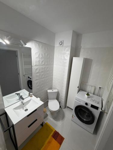 a bathroom with a sink and a washing machine at White House in Ploieşti