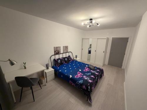 a bedroom with a bed and a desk and a chair at White House in Ploieşti