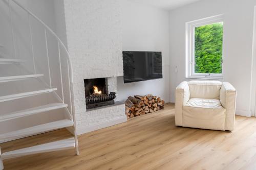 a living room with a chair and a fireplace at Spaanse Galeien 13 in Retranchement
