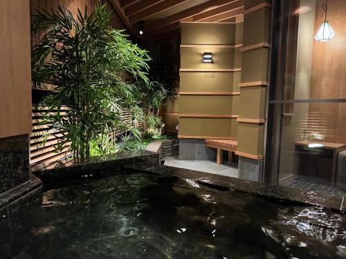 a koi pond in the middle of a building at Tatsumikan in Minakami