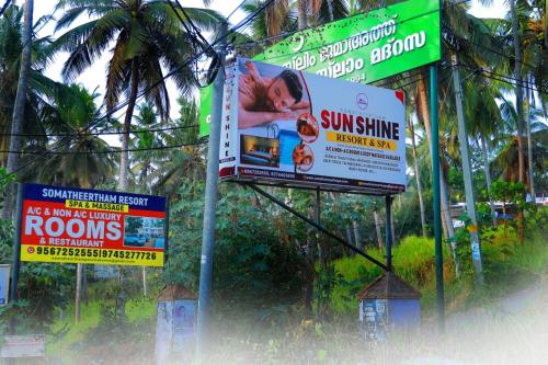 a bunch of signs on the side of a street at Sun Shine Resort & Spa in Kovalam