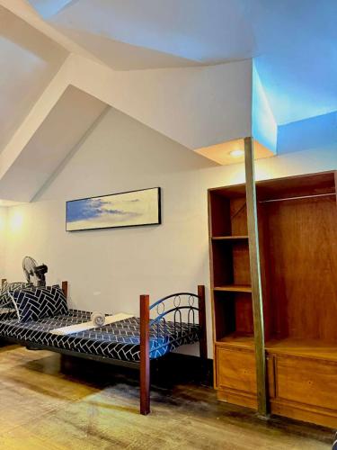 a bedroom with a bed in a room with a ceiling at Chad's Lodge in Coron