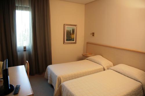 Postel nebo postele na pokoji v ubytování Hotel Bassetto