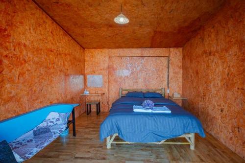 a bedroom with a bed in a wooden room at Mon Ngo misty haven B1 in Ban Mae Ta Man