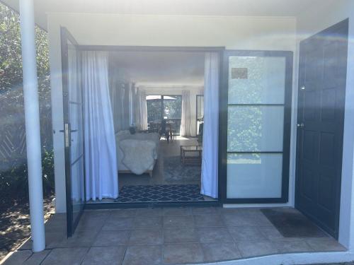an open door to a room with a living room at Stunning Mount beachside location in Mount Maunganui