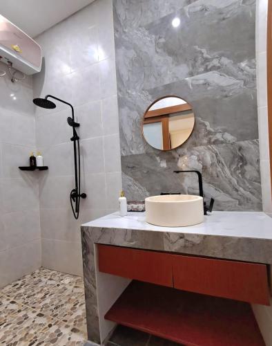 a bathroom with a sink and a mirror at Best Value Room Sanur Walk to Beach - NVB in Sanur