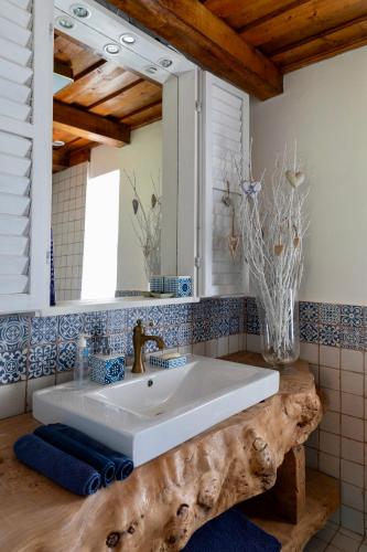a bathroom with a white sink and a mirror at PusztaFarm - Boutique Retreat with Wellness 6 to 8 Guests in Fülöpháza