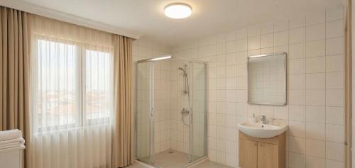 a bathroom with a shower and a sink at Kaptanlar in Side