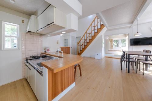 an open kitchen and dining room with a table at Shakunagedaira Rental cottage - Vacation STAY 18459v in Numanokura