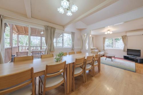 a dining room with a large wooden table and chairs at Shakunagedaira Rental cottage - Vacation STAY 18463v in Numanokura