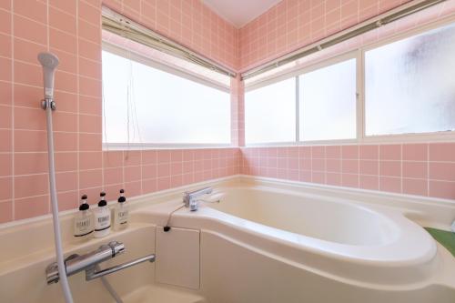 a pink bathroom with a tub and a window at Shakunagedaira Rental cottage - Vacation STAY 18463v in Numanokura