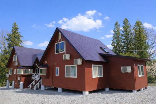 a large red house with a black roof at Shakunagedaira Rental cottage - Vacation STAY 18463v in Numanokura