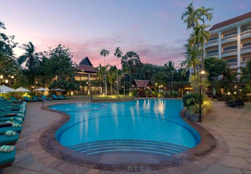 a pool at a resort at night at THE PRIVILEGE FLOOR by Borei Angkor in Siem Reap