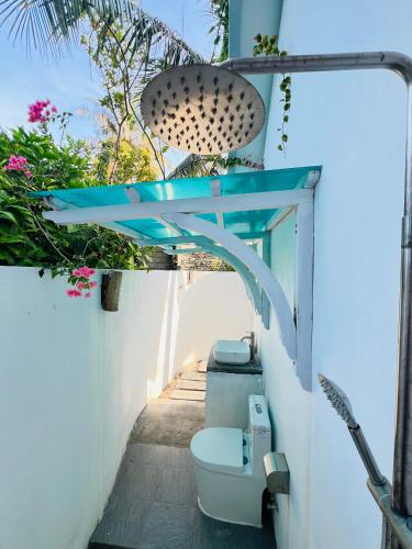 a bathroom with a toilet and a sink at 101 Sosi in Kudafari