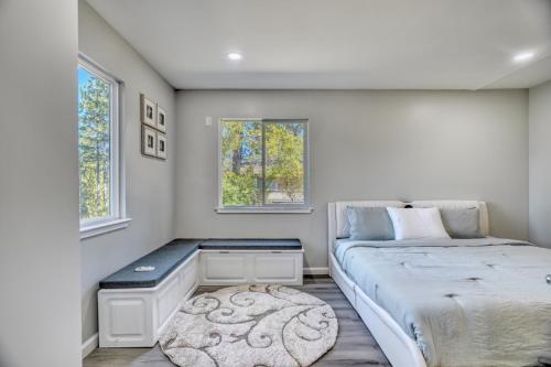 a bedroom with a bed and two windows at Modern Luxury Sierra Lodge | 3BR, 3BA | Hotel Vibe in Groveland