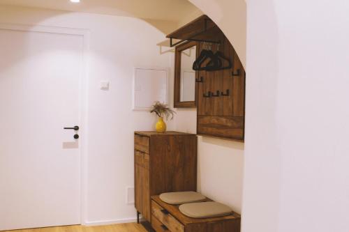 a room with a stool and a mirror on the wall at Apartment TrentaTre in Chiusa