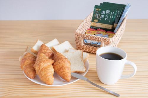 a plate of croissants and a cup of coffee at Shakunagedaira Rental cottage - Vacation STAY 18466v in Numanokura