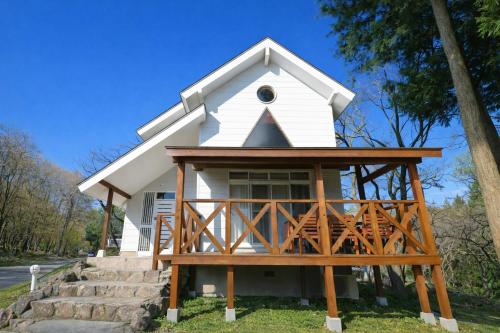 a small white chapel with a wooden porch at Shakunagedaira Rental cottage - Vacation STAY 18466v in Numanokura