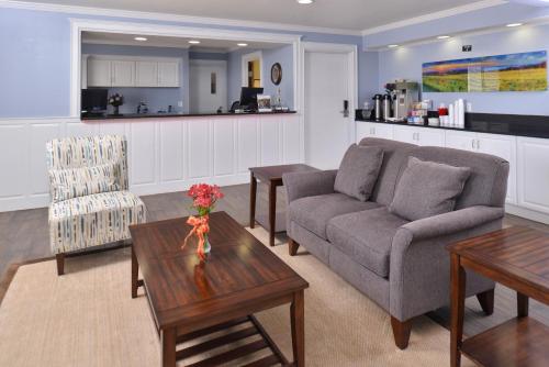 a living room with a couch and a table at Americas Best Value Inn & Suites-Birch Run in Birch Run