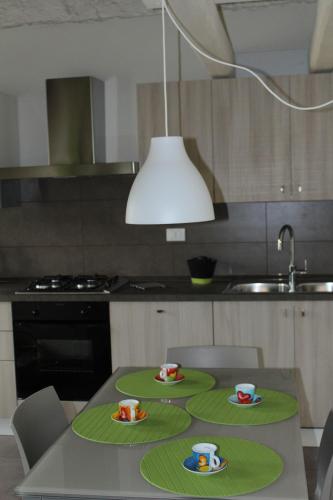 a kitchen with two plates and cups on a table at Casa Diso 2016 in Vittorio Veneto