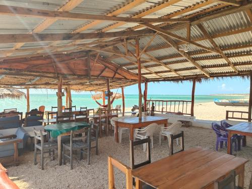 a restaurant on the beach with tables and chairs at Chez Émile in Anakao