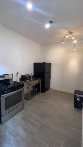 a kitchen with a black refrigerator and a stove at La Cienega Soul in Los Angeles