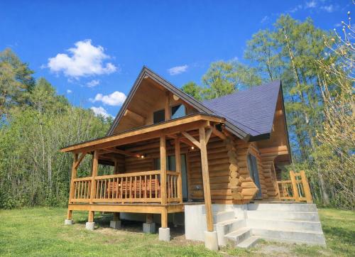 a cabin in the woods with a large deck at Shakunagedaira Rental Cottage - Vacation STAY 18468v in Numajiri