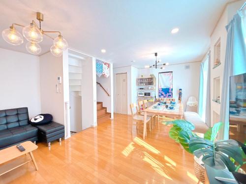 a living room with a couch and a table at Ikebukuro area, three layer house, double subway,5 min walk to stn, 双地铁车站步行5分 直达新宿 涩谷 银座 池袋 皇居 可免费停车 最大10人 in Tokyo