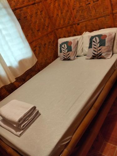 a bed with towels and napkins on it at Lucia's Native House in Lalao