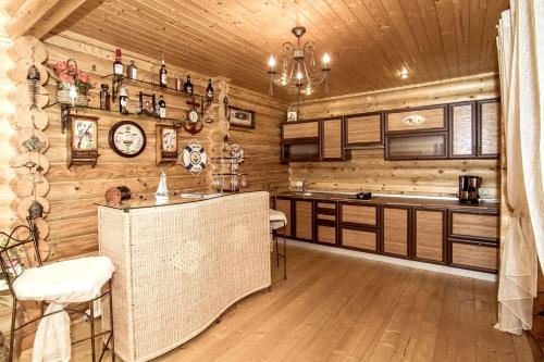 una cocina con paredes de madera y un reloj en la pared en Tihaya Gavan, en Vylkove