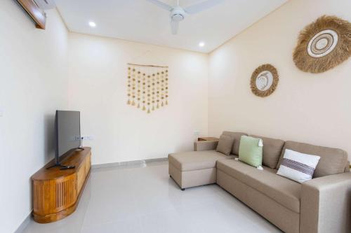 a living room with a couch and a television at Villa Surga in Denpasar