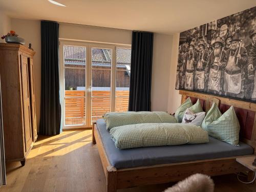 a bedroom with a bed with a cat sitting on it at Wohnung Kirchstein Highlight Fliegenfischen auf der Isar in Lenggries