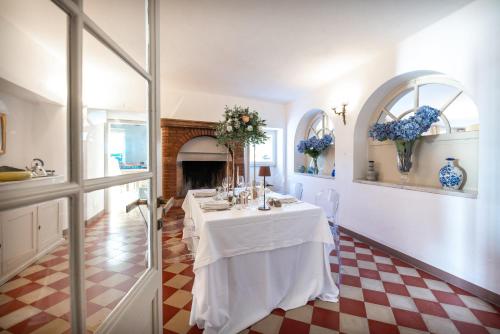 a dining room with a table and a fireplace at Le Selve Lake View Villas in Toscolano Maderno