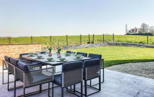 a dining table and chairs on a patio at 5 Bedroom Beautiful Home In Oudenaarde in Oudenaarde