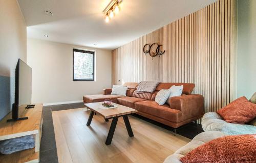 a living room with a couch and a table at 5 Bedroom Beautiful Home In Oudenaarde in Oudenaarde