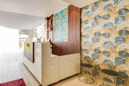 a lobby with a counter and stools in a room at FabHotel Relax Inn Executive in Pune