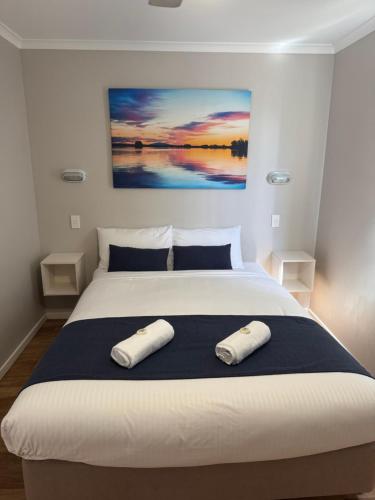 a bedroom with a large bed with two pillows on it at Clarence Head Caravan Park in Iluka