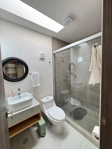 a bathroom with a toilet and a sink and a shower at BellitasHouse Dream Acapulco Lujo y Confort in Acapulco
