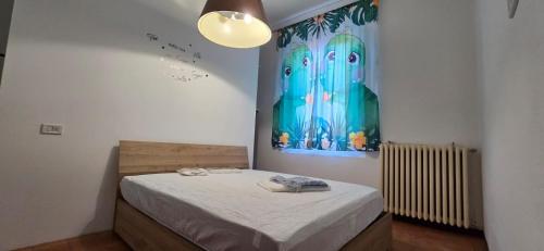 a bedroom with a bed and a painting on the wall at The SISTERS in Castel Maggiore