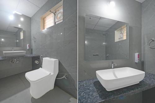 a bathroom with a toilet and a sink and a mirror at FabHotel Palm Tree in Hyderabad
