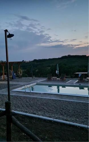 a large swimming pool with chairs and a table at Etno Vila Ognjilo in Kragujevac