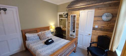 a bedroom with a bed and a clock on the wall at Salisbury Guest House - free parking in York