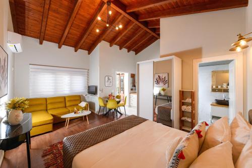 a bedroom with a bed and a living room at Blerina's Agritourism Concept in Laknas