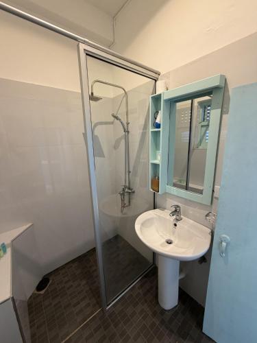 a bathroom with a sink and a shower at Sri Gemunu Beach Resort in Unawatuna