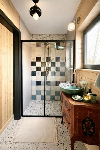 a bathroom with a shower with a glass door at Nastawka Cottage Creativity and Regeneration in Raciechowice