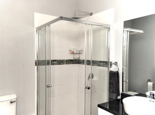 a glass shower in a bathroom with a sink at River Bend Farm in Lidgetton