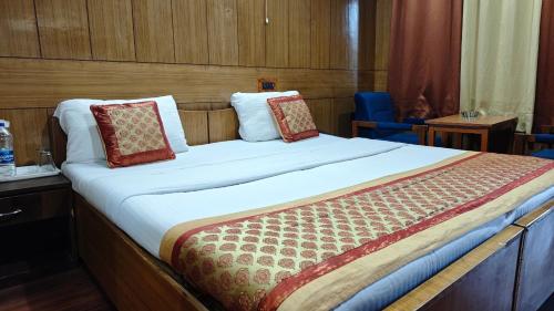 a bedroom with a large bed in a cruise ship at Hotel Ech Aar, Kargil in Kargil