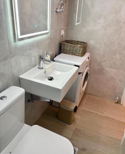 a bathroom with a sink and a toilet at Nikoletta's Studio 2 in Komotini